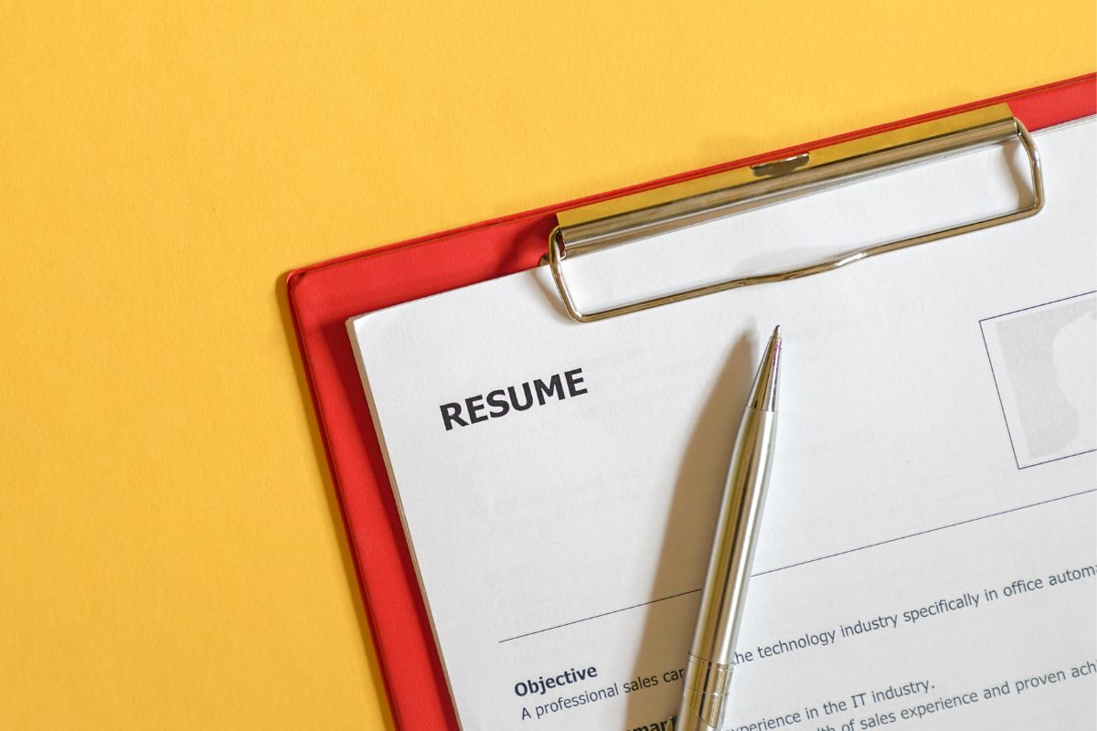 The image shows a pen and a clipboard with papers and notes which means highlighting soft skills through action-based examples makes your resumer stronger that hiring managers prefer proof over buzzerwords.