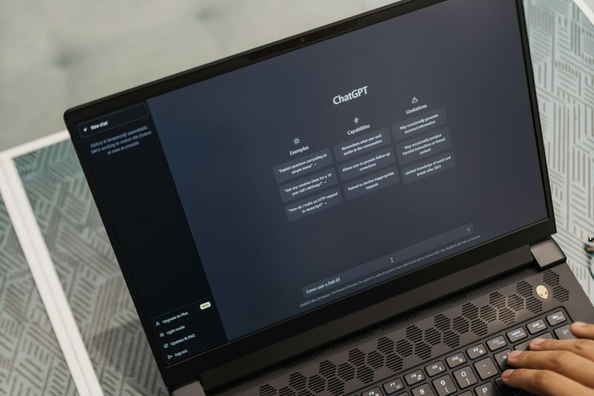 Image shows a man's hand using a Chat GPT.
