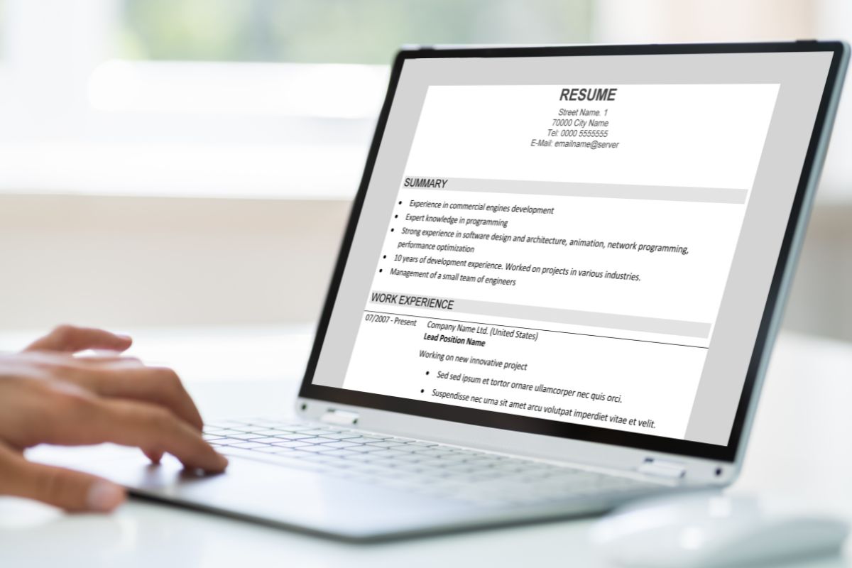 The photo shows a girl's hand using a laptop with a screen display referring to include AI-related skills can make you more valuable and help you get higher-paying jobs.