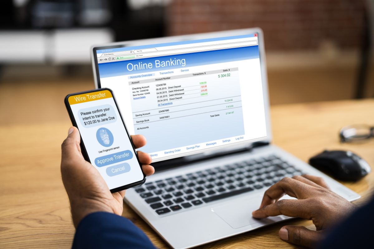 The picture shows a man's hand setting up an automatic transfer.
