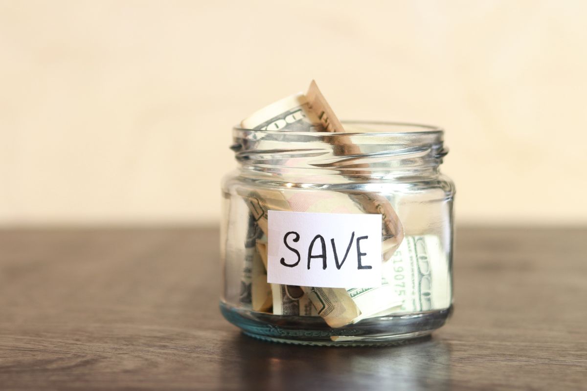 The image of a jar with money for a weather savings hack,