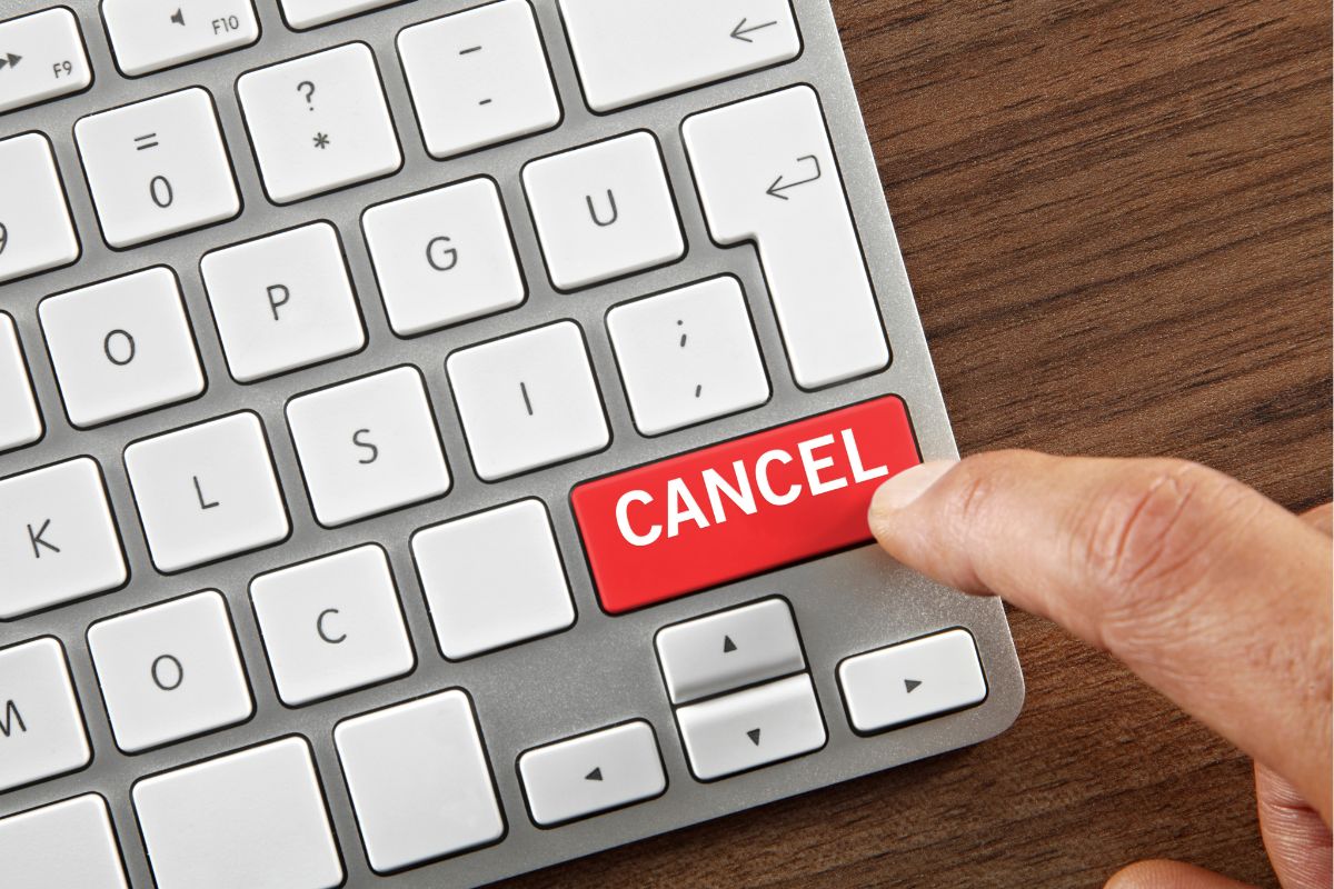 Image of a man's hand canceling his subscriptions.