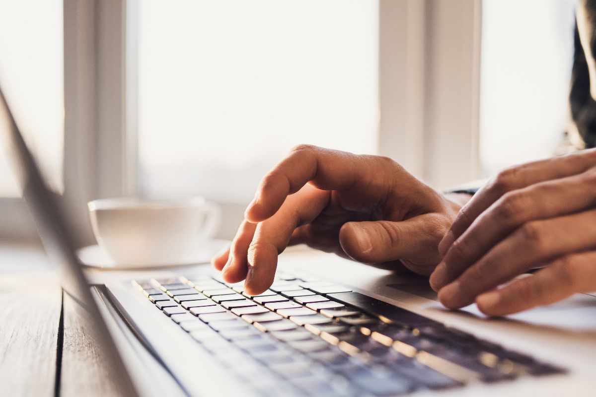 The picture shows a man's hand using AI-powered savings tools.