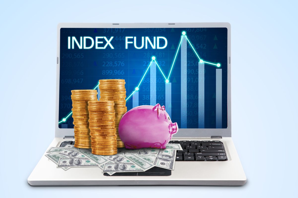 The image shows a laptop with a graph and notes, coin stocks, a piggy bank, and dollar bills referring to investing early and consistently in index funds letting time and compound interest do the heavy things, and building long-term wealth with minimal effort.