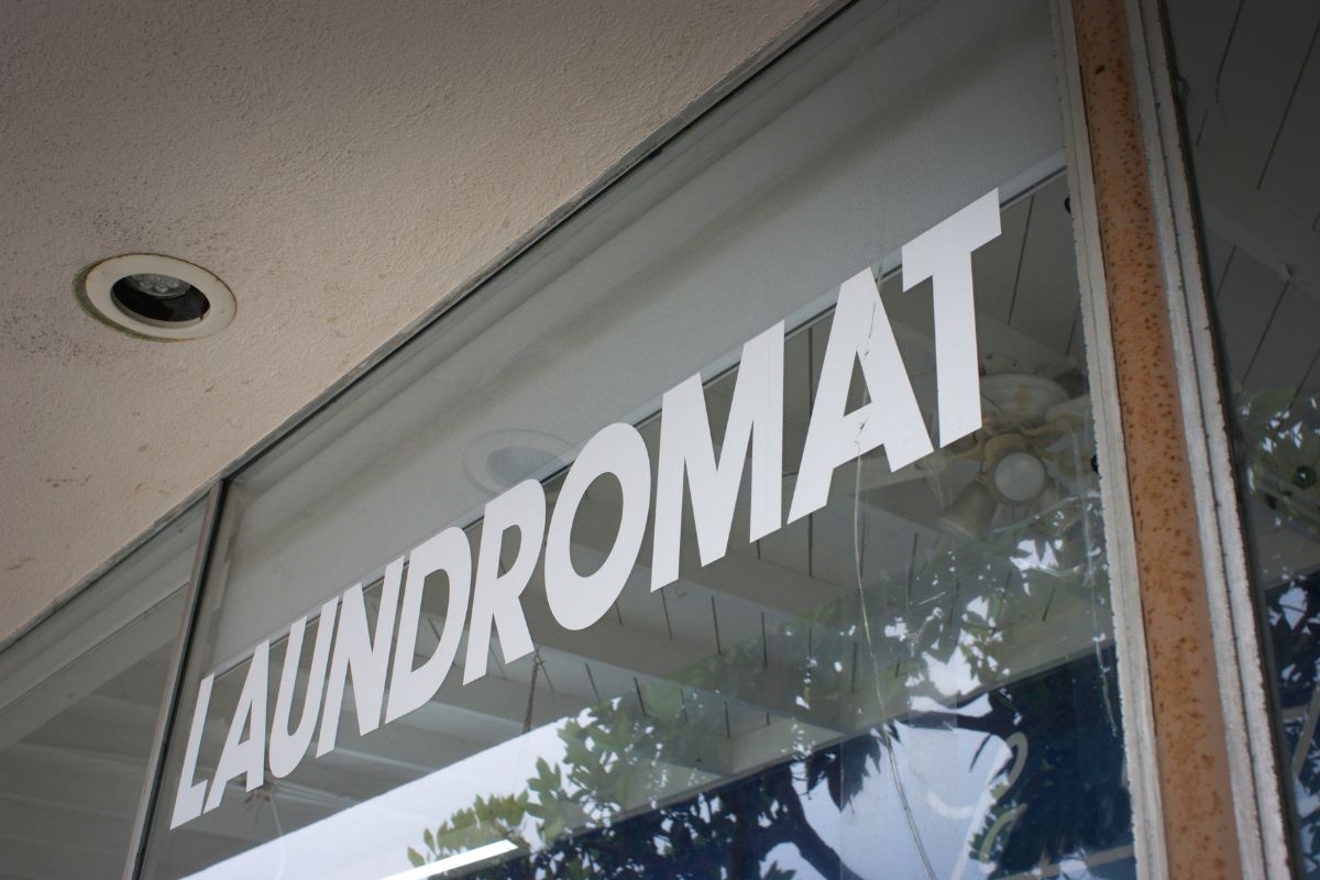 The image tells about a shop with a name indicating that leveraging boring businesses like Laundromats can grow your wealth even faster.