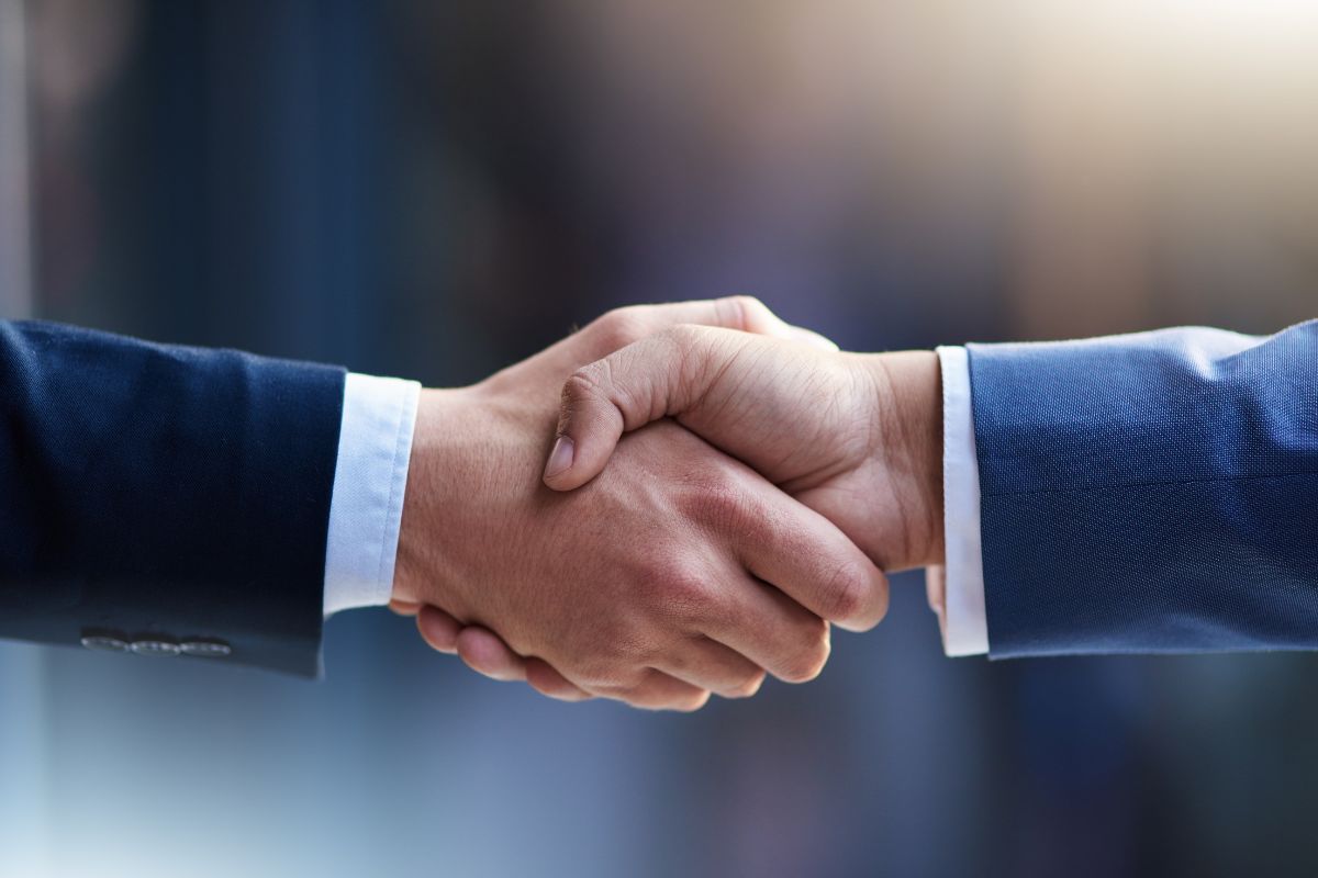 The image shows shaking hands together indicating to utilize other people's money by partnership to scale investments letting you buy more assets and multiple returns.