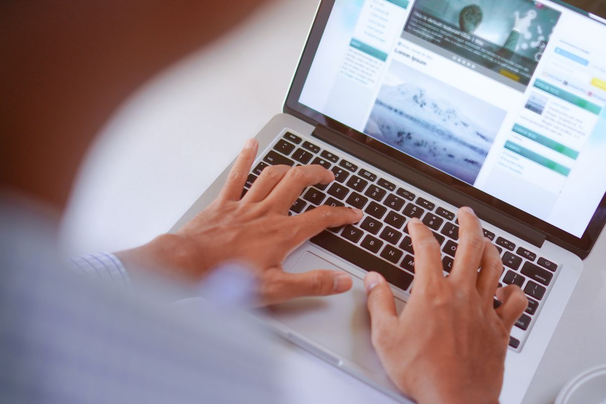 The image shows a man's hand typing on a laptop with a screen display indicating that creating content that generates passive income can keep earning long after the work is done.