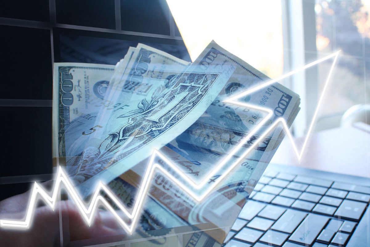 Image of a laptop and investment money.