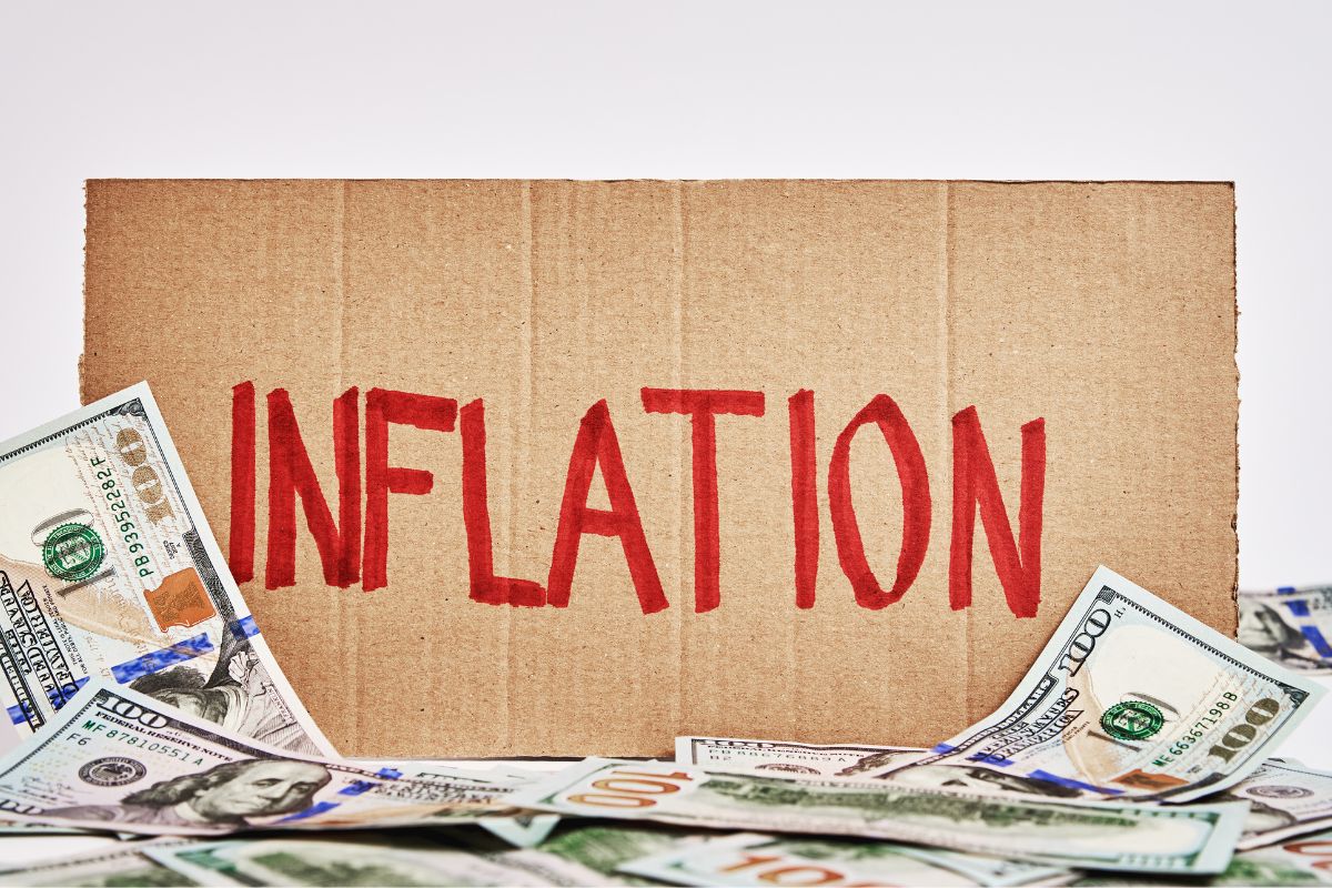 Photo of money and board with inflation wording.