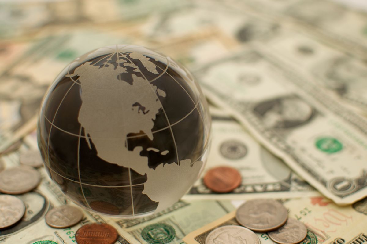 The photo shows money and a globe.