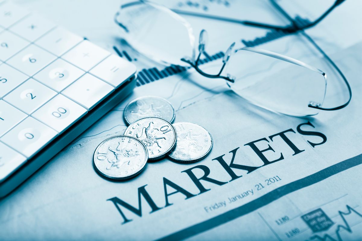 The image shows a calculator and a markets wording.