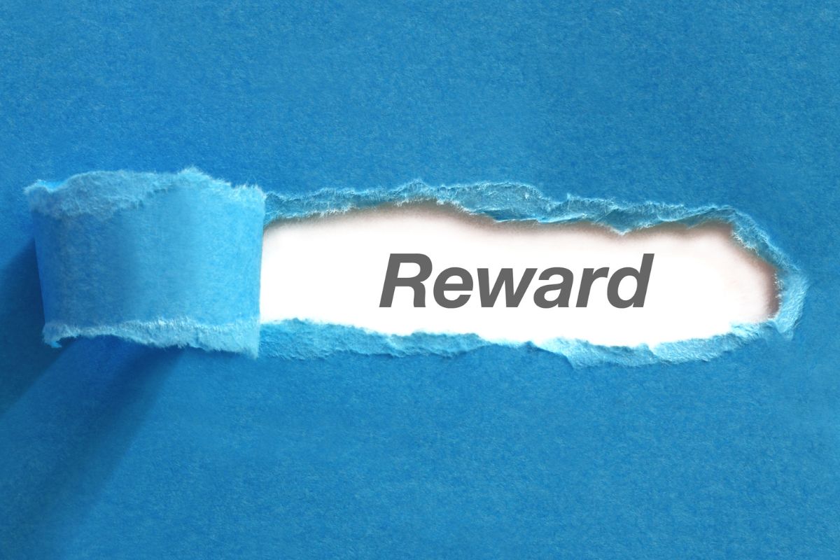 The photo shows torn paper with reward wording.