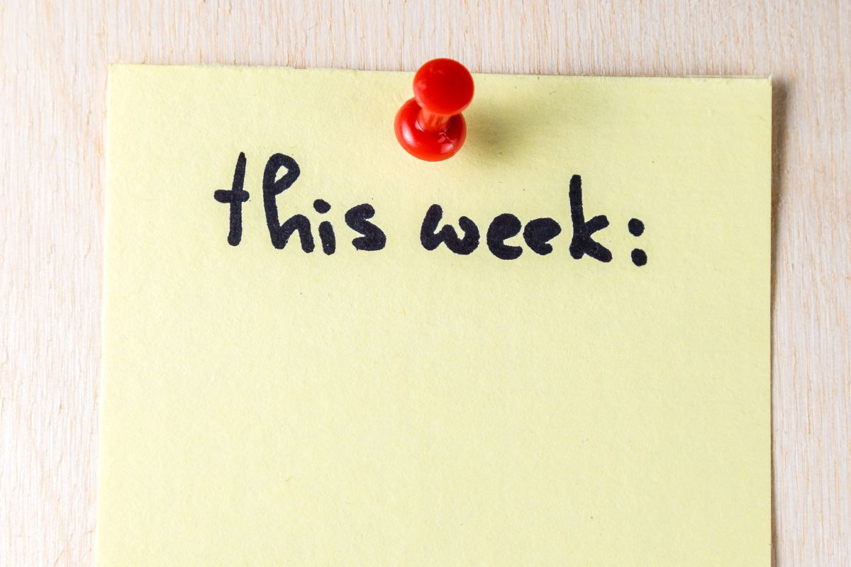 The picture shows a piece of paper with notes and a pin on the wall referring to the use of the one-week rule, which makes a no-spend challenge easier by cutting down on mindless spending.