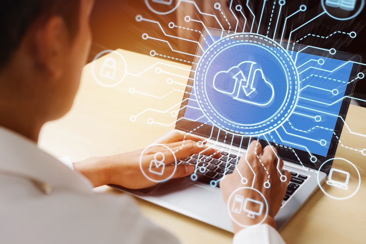The picture of a man using a laptop with visual displays of icons indicates that creating a personal Monopoly helps you charge higher prices and creates opportunities others can't compete with.