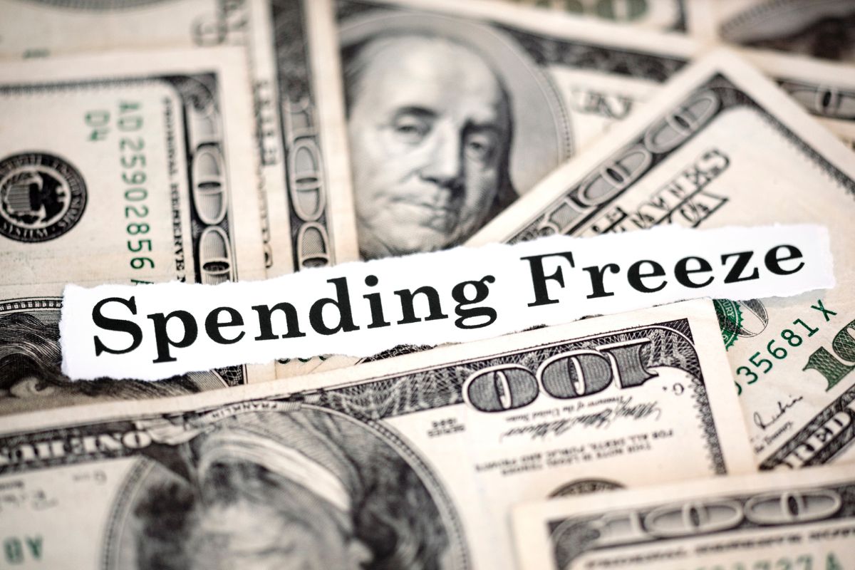 Image of a paper with spending freeze wording.