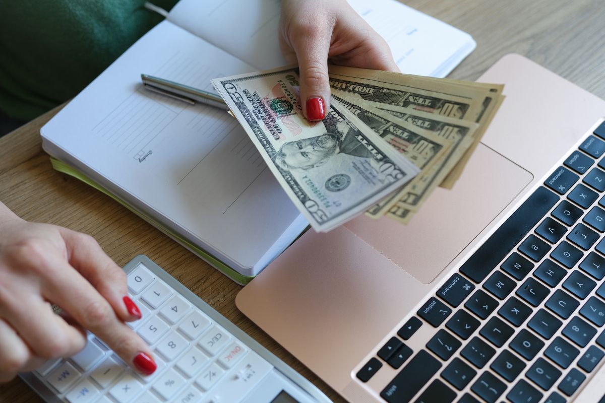 Image of a woman's hand budgeting money.