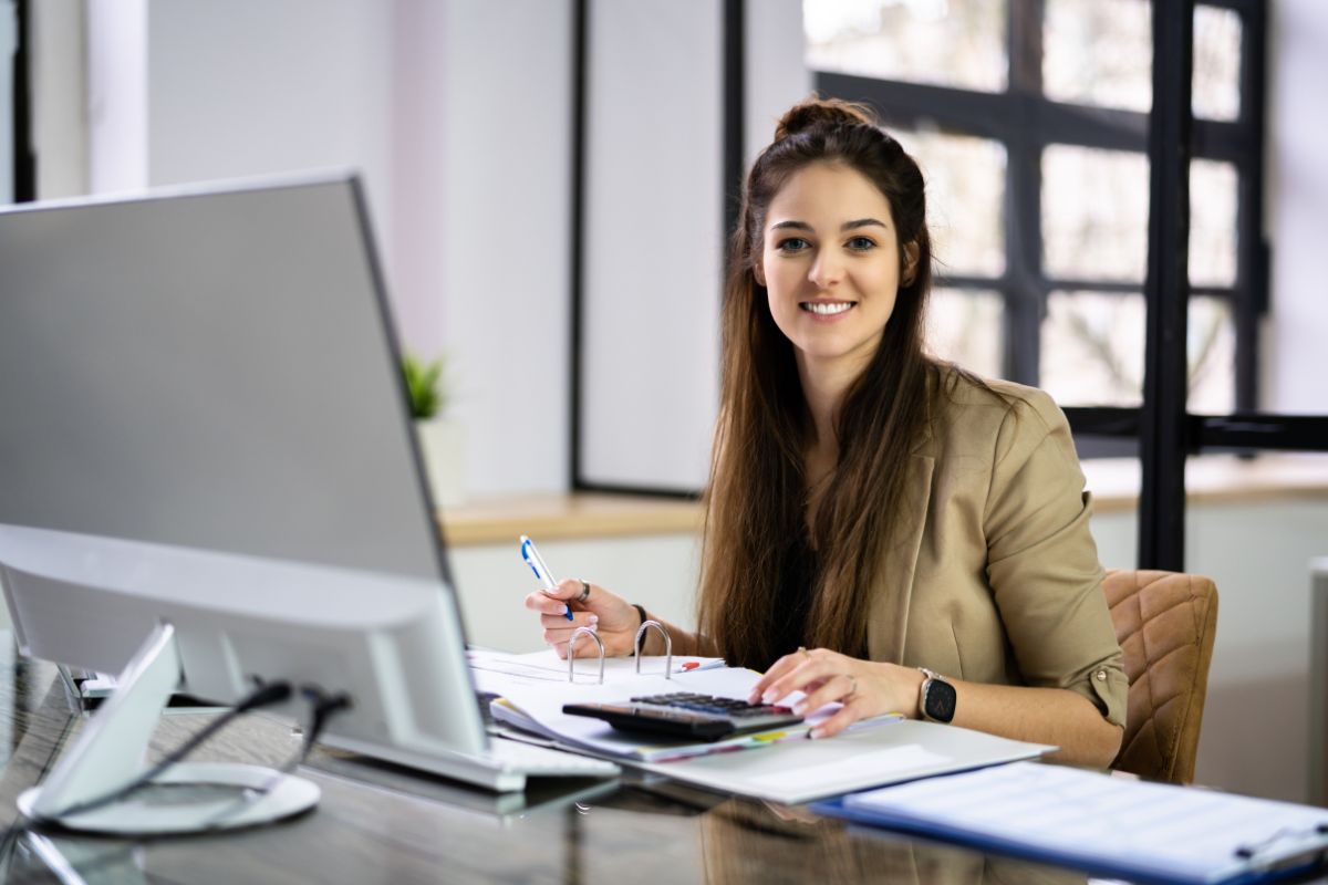 The photo shows a woman working as a bookkeeper.