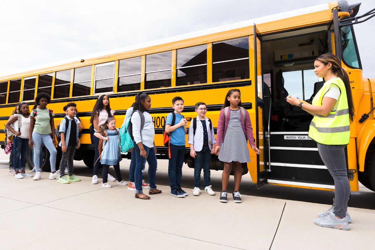 Image of students and a school bus monitor.