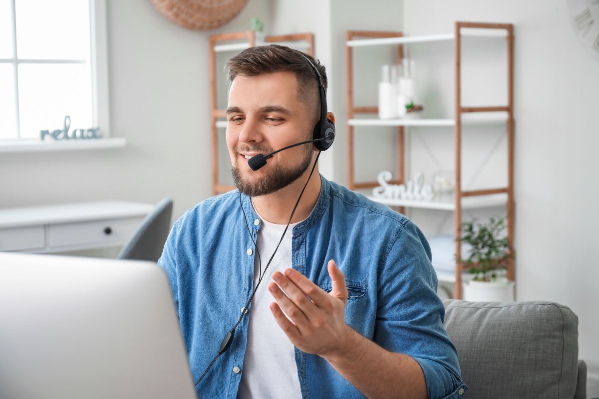 the image shows a man talking while using a laptop and headphone which means an online chat agent is one of the best part-time jobs for people who prefer working behind a screen.