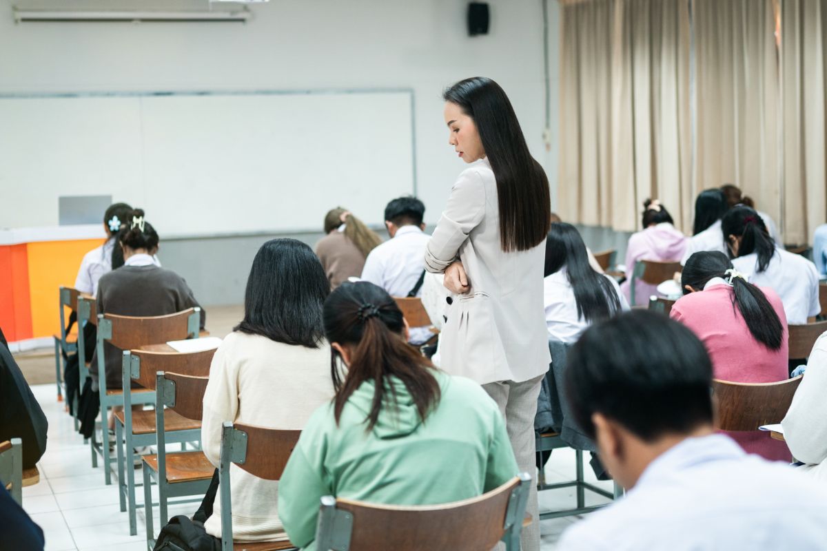 The picture of the students and a test proctor.