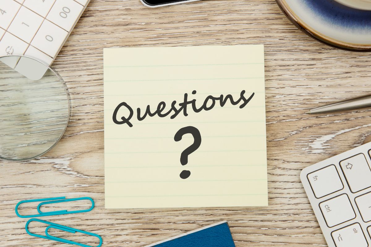 An image shows a paper with questions written.