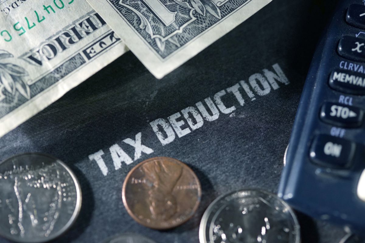 The image shows money and tax deduction wording.