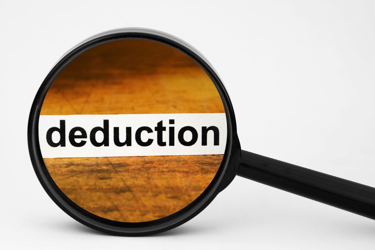 The image shows a magnifying glass focusing on a word indicating to taking the standard deductions without checking if itemizing would save them can add up to a bigger deduction. 
