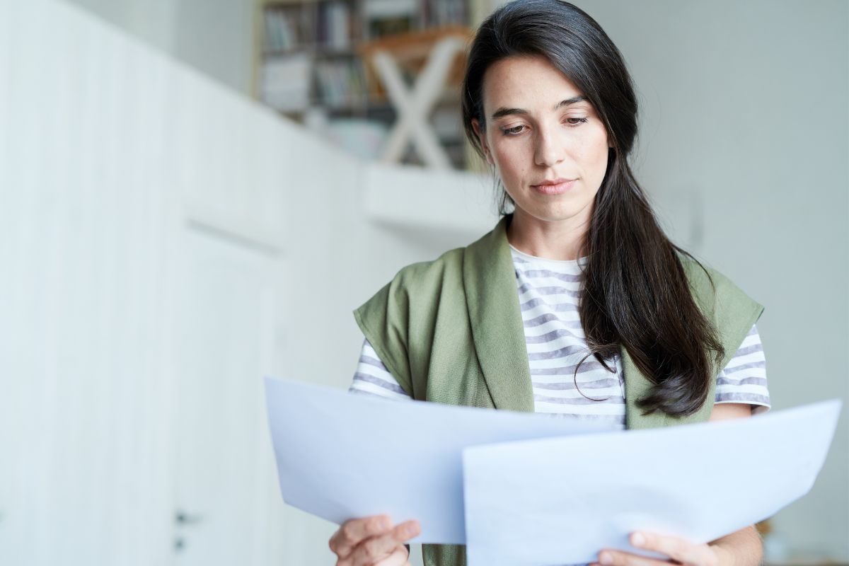 The image tells about a girl looking at the papers referring to misclassifying dependents could mean missing tax breaks, correcting it can make a big difference.