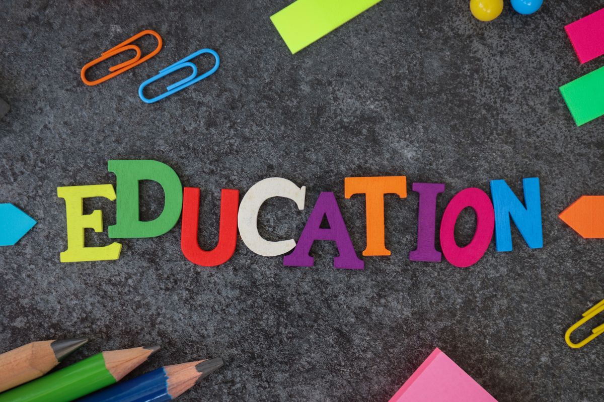 The picture shows clips, pens, and education wording.