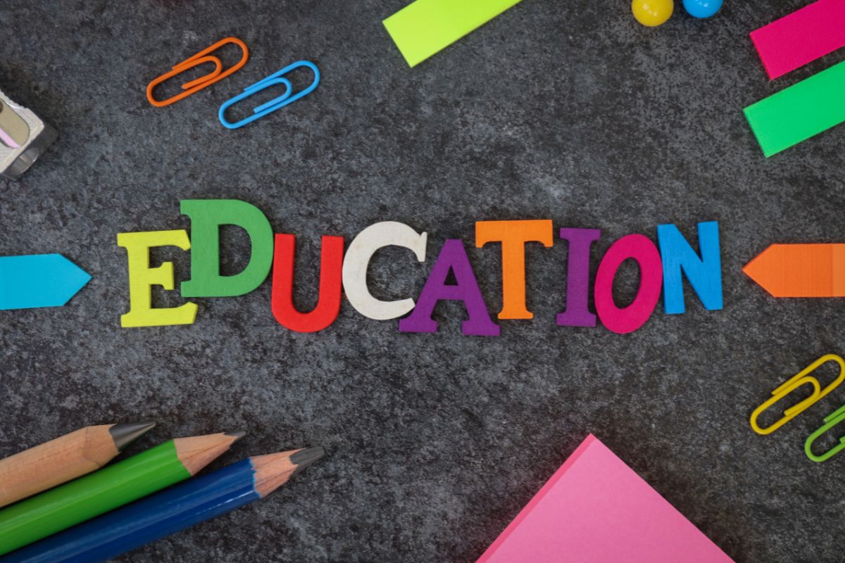 The picture of paper clips, sticker notes, pens, and letters on the board referring to overlooking education credits can lower the amount you owe and can save money.
