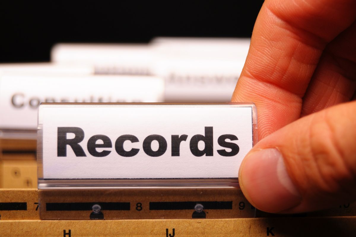 Image of a man's hand and record files.