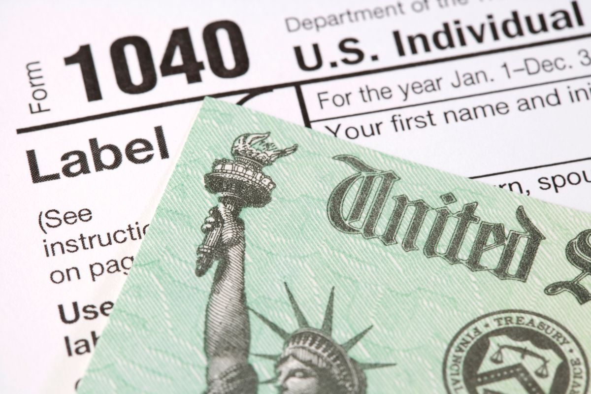 The photo shows papers with notes and an icon indicating how to file taxes goes a long way in lowering your tax bill.