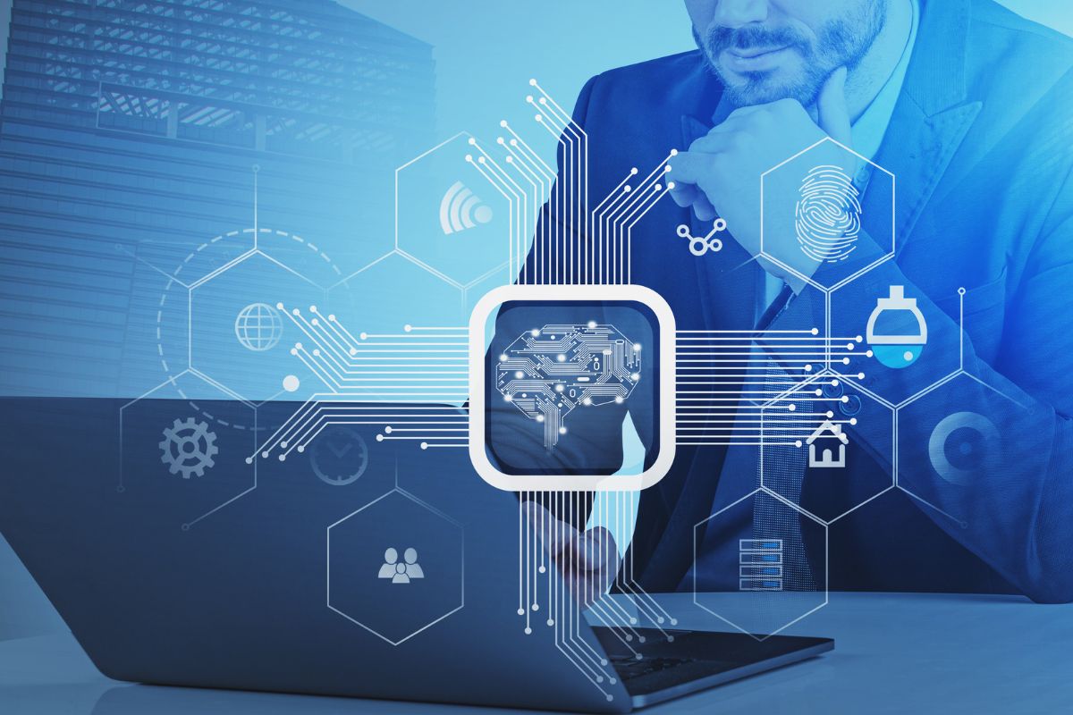 The image shows a man using a laptop with visual icons on the screen which means working as artificial intelligence and machine learning is one of the in-demand skills that has a high earning potential.