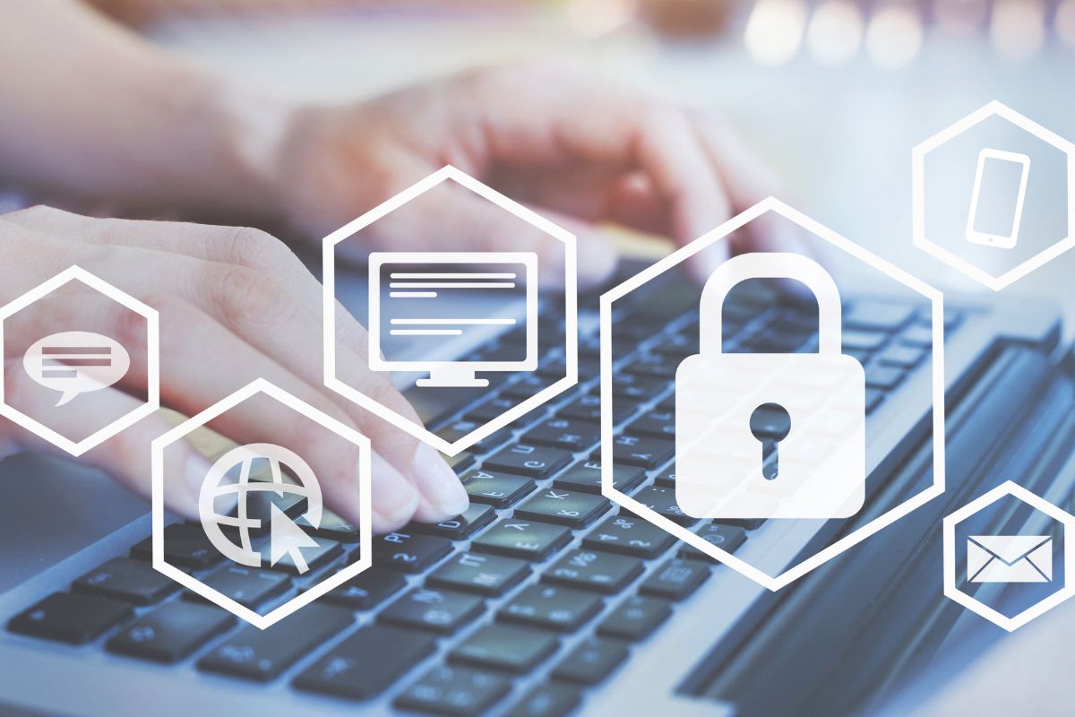 The image shows a man's hand using a laptop with visual icons on the screen referring to cybersecurity is a job that protects businesses from cyber threats and data breaches with a high-income salary.