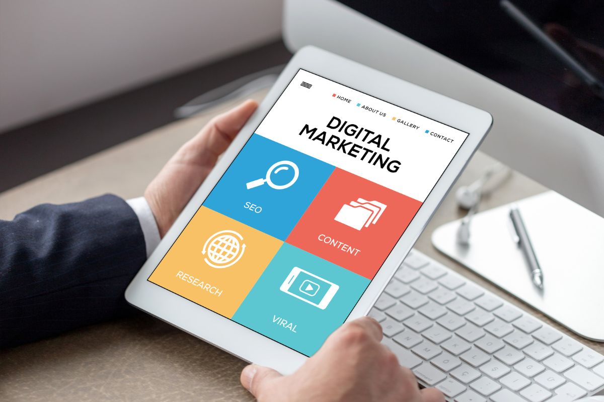The photo shows a man's hand learning digital marketing.