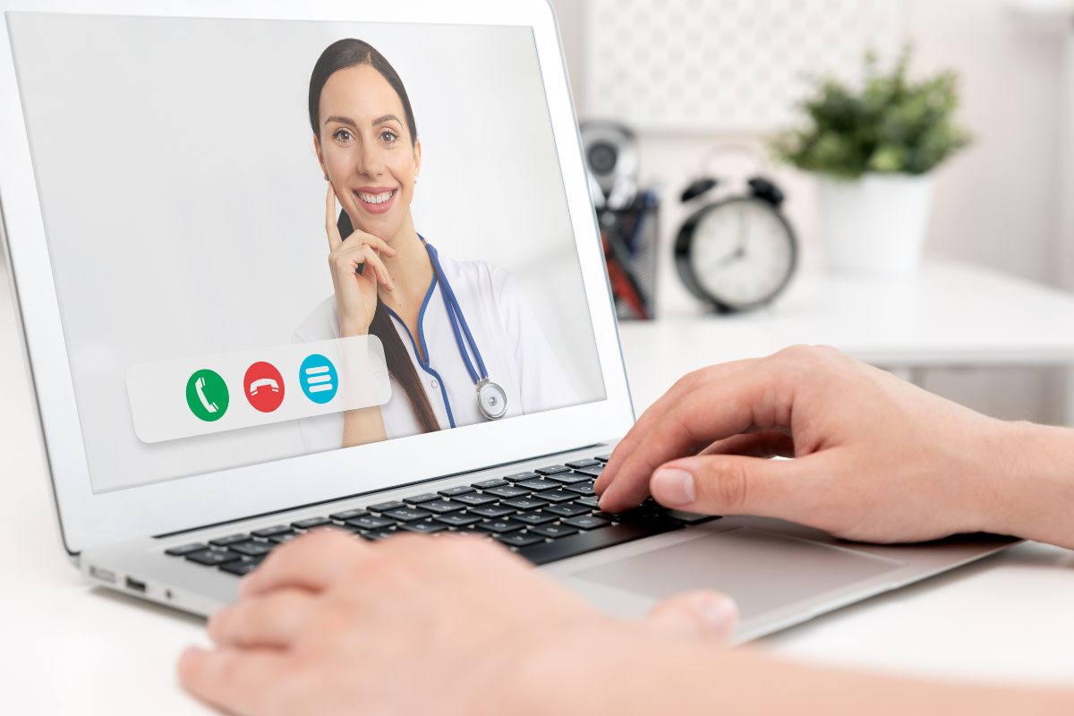 The photo shows a girl using a laptop while on a call with a nurse online which means healthcare and telemedicine allow to provide healthcare services remotely as a way to earn money and help others.