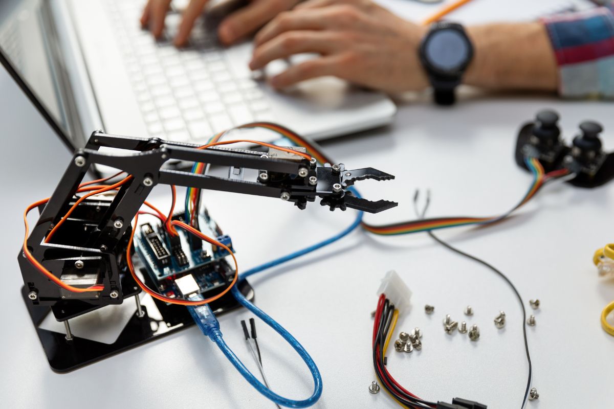 The picture shows a man working on automation and robotics.