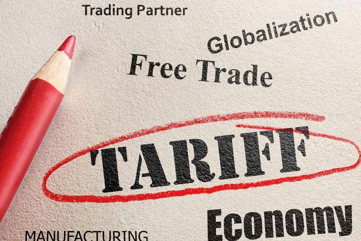 The picture shows a paper with tariff policies and a pen.