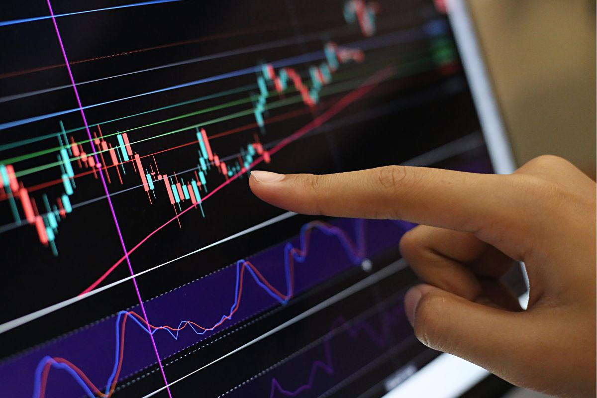 Photo shows a woman's hand investing,