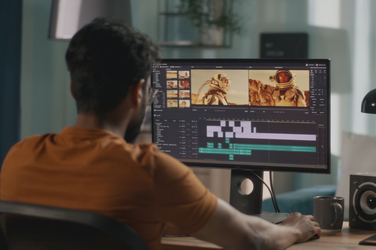 Image of a man video editing.