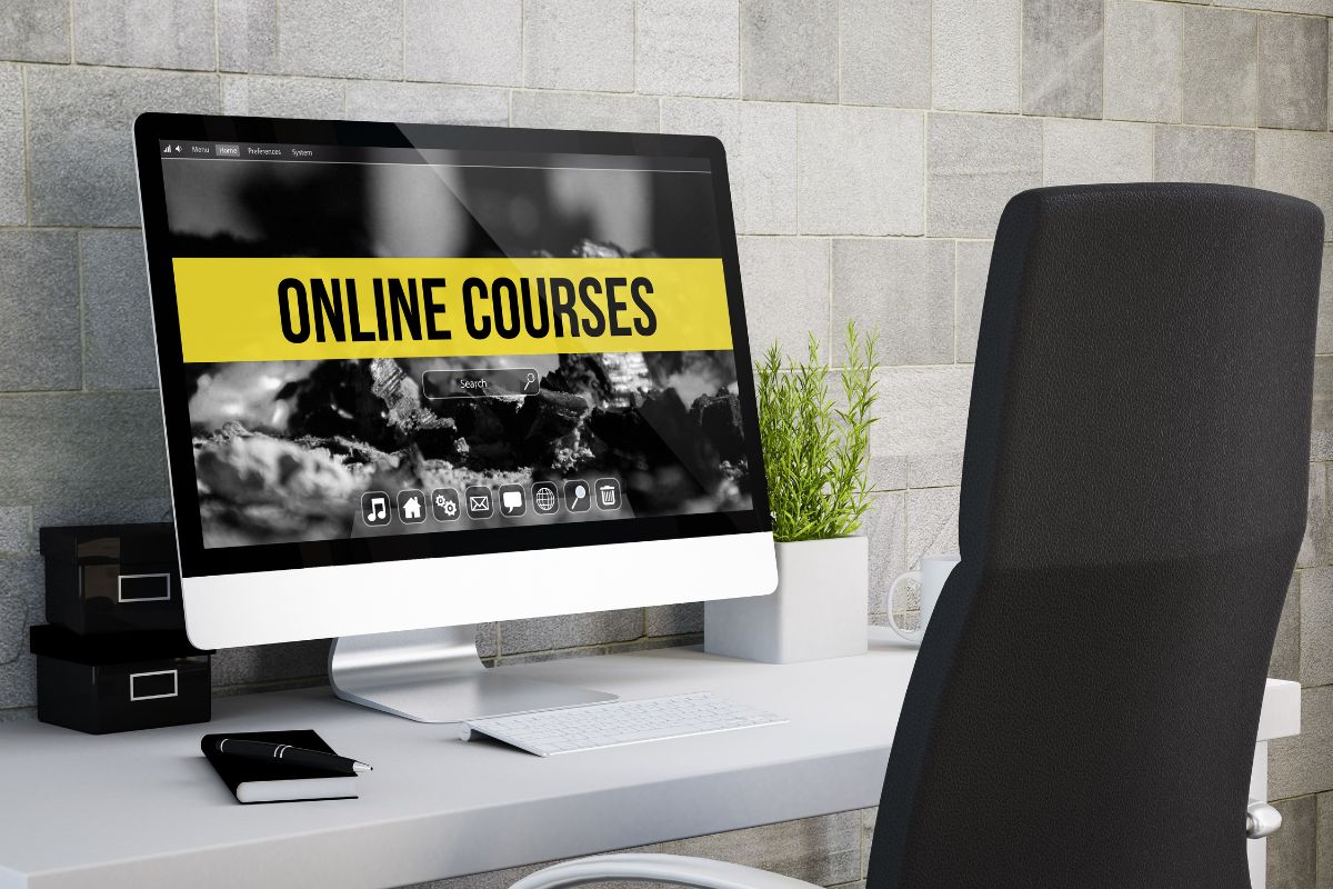 The photo tells about a chair and a monitor with a screen display indicating an online course creation by sharing knowledge with others in exchange for money.