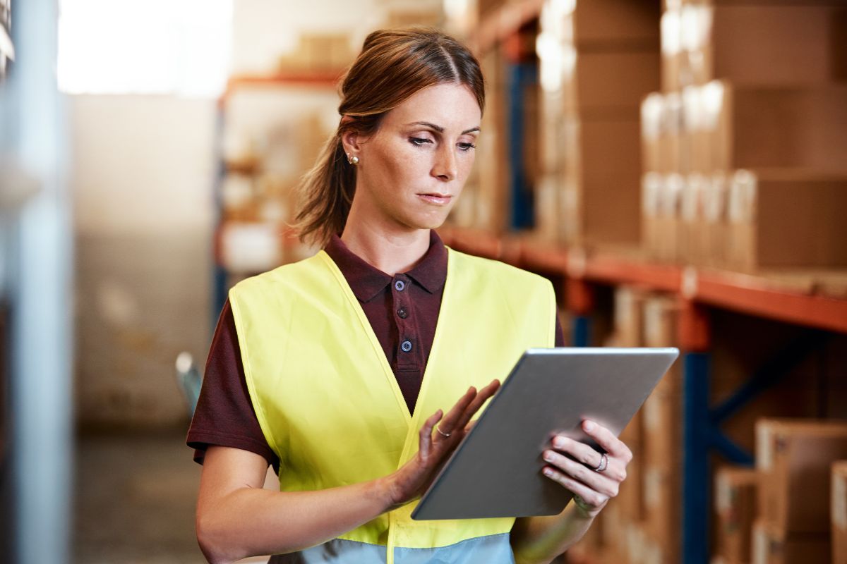 Image shows a woman monitoring the supply chain.