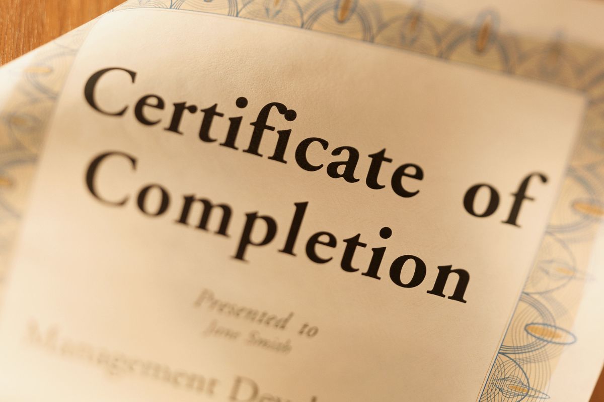 The photo shows a piece of paper with notes referring to investing in yourself to get ahead helping you stand out from other job seekers.