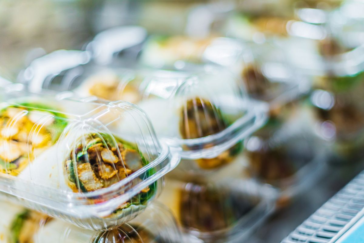 The photo shows foods inside the plastic container referring to skipping pre-packaged items helps to reduce costs on groceries.