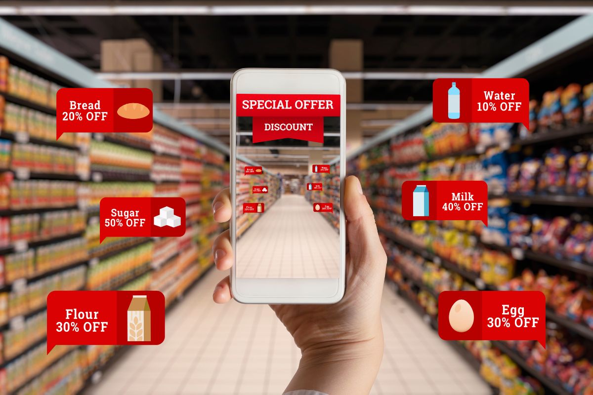 A photo of a woman's hand looking for grocery discounts.