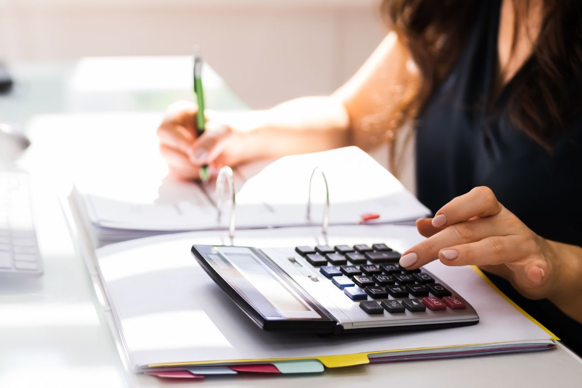 The photo of a woman calculating her net worth.