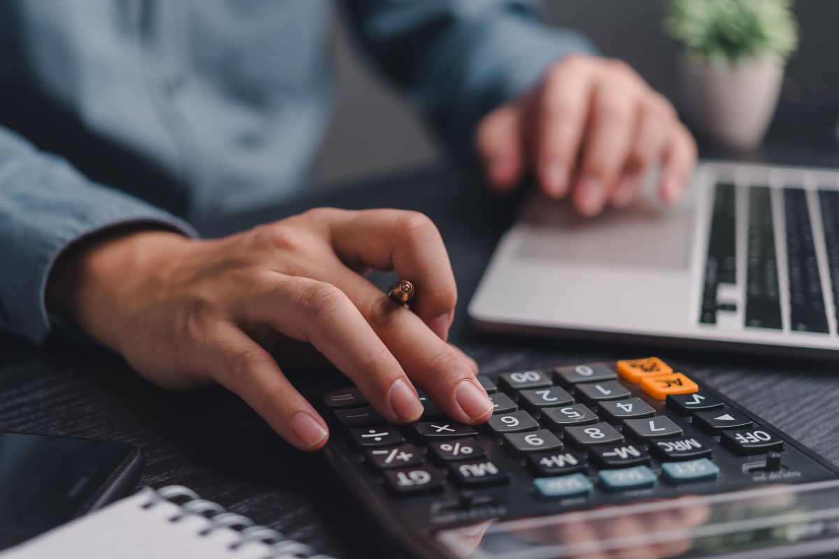 The picture shows a man's hand budgeting.