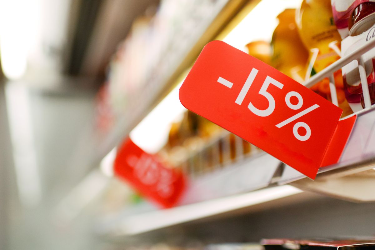 The photo shows item displays and red signage referring to stock up on loss leaders save money on groceries.