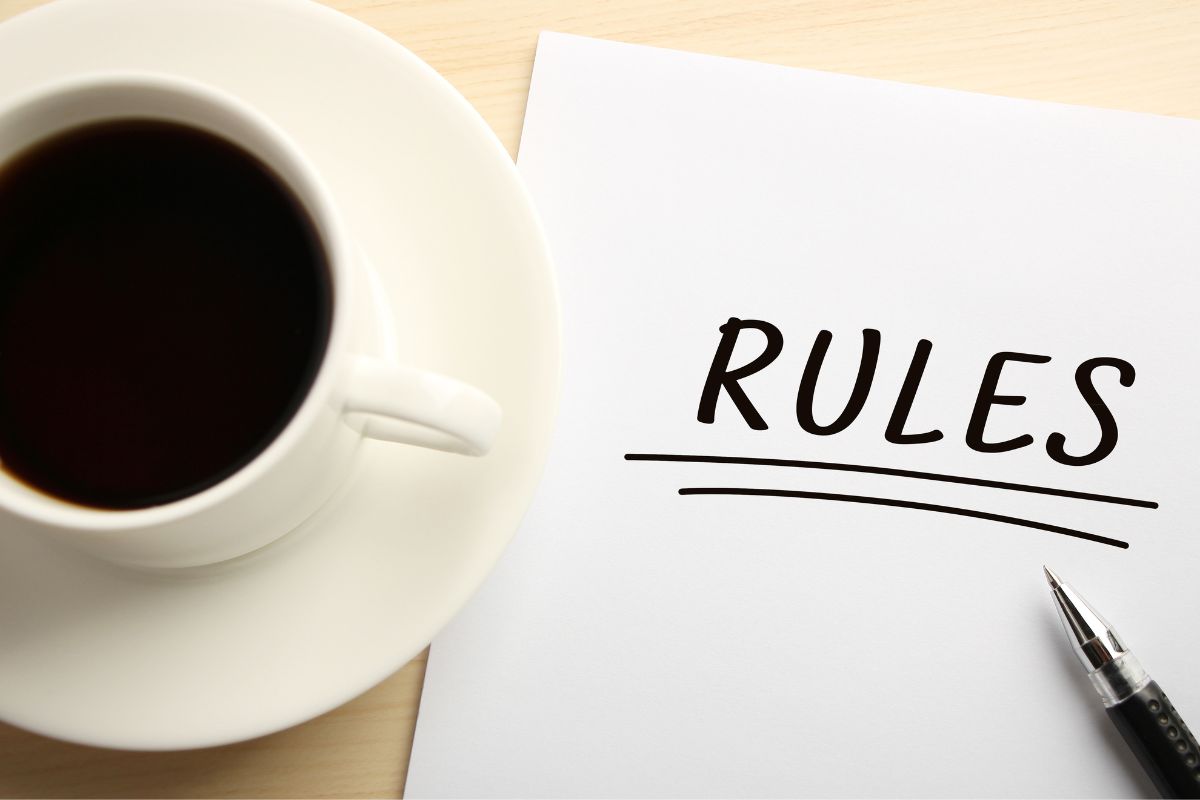 Image of a coffee and a paper with rules written.