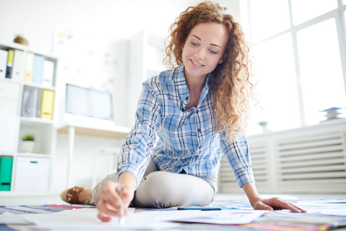 The photo shows a girl checking on the papers indicating that turning setbacks into lessons makes you smarter with money.